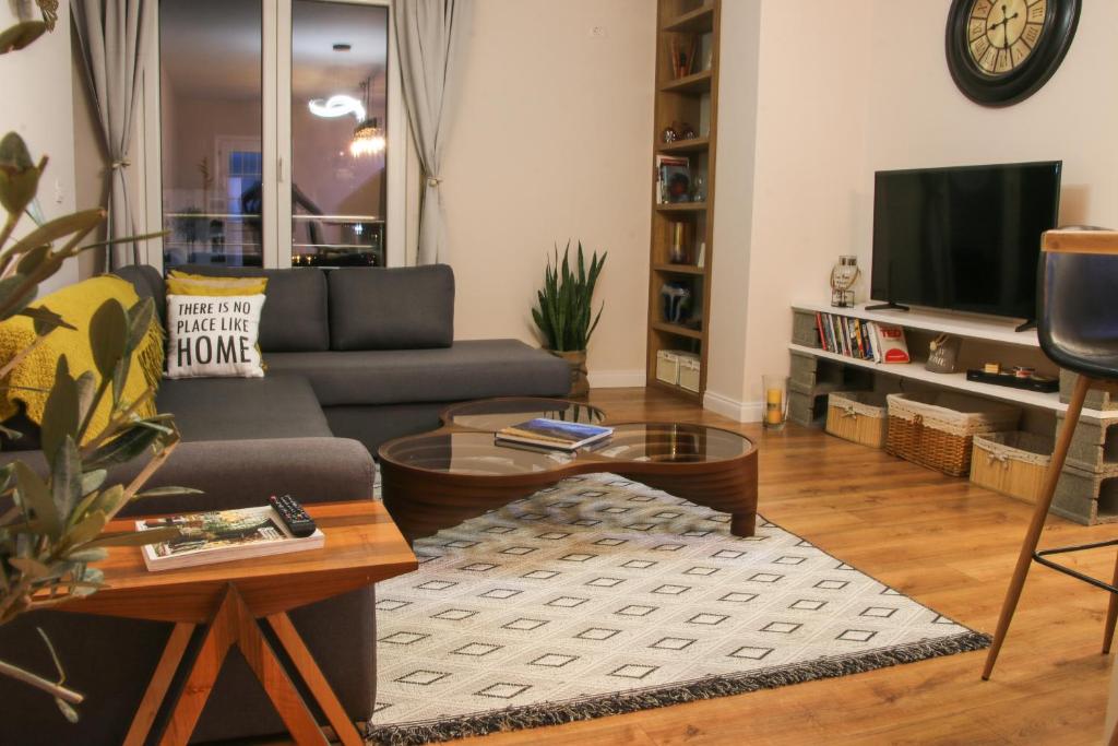 a living room with a couch and a coffee table at City Centre Apartment 2 in Shkodër