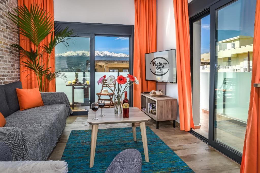 a living room with a couch and a table at Vintage City Apartments in Chania