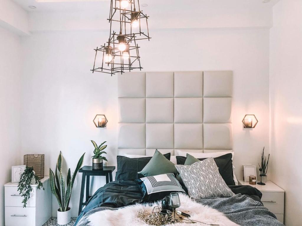 um quarto com uma cama e um lustre em Soderberg ( Near Airport | 50mbps Wifi | Netflix ) em Mactan