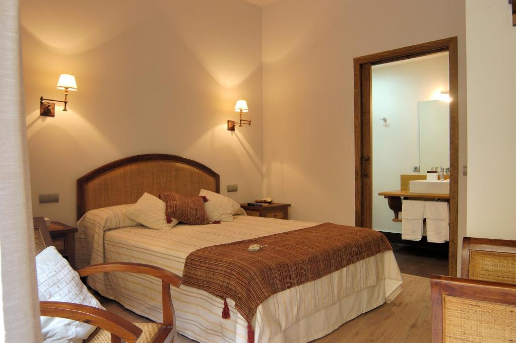 a hotel room with a bed and a bathroom at Casa Rural La Botica in Oropesa