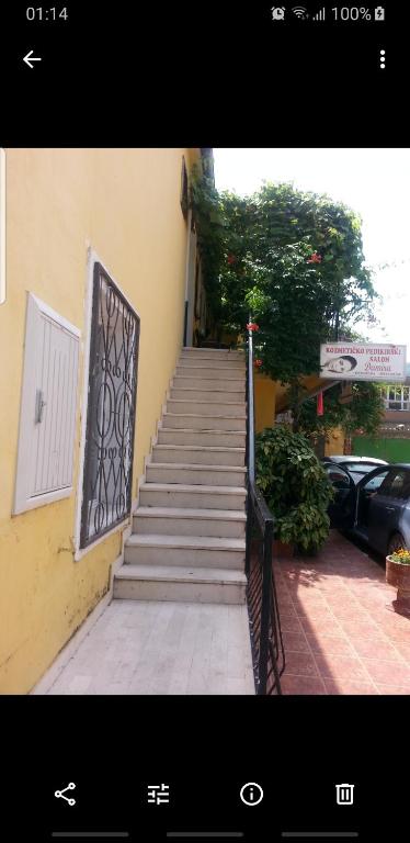 a staircase leading to a building with a gate at Apartment Kiki in Kotor