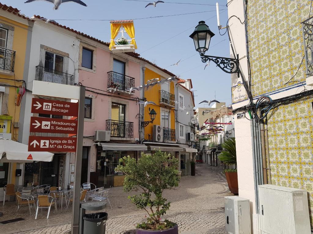 an empty street with tables and chairs and buildings at 5 Rua Antão Girão II in Setúbal