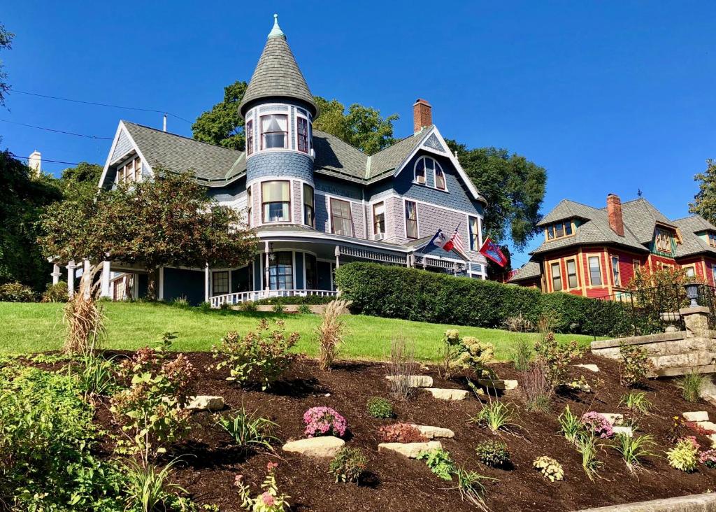 a large house with a garden in front of it at The Hancock House Bed & Breakfast Inn in Dubuque