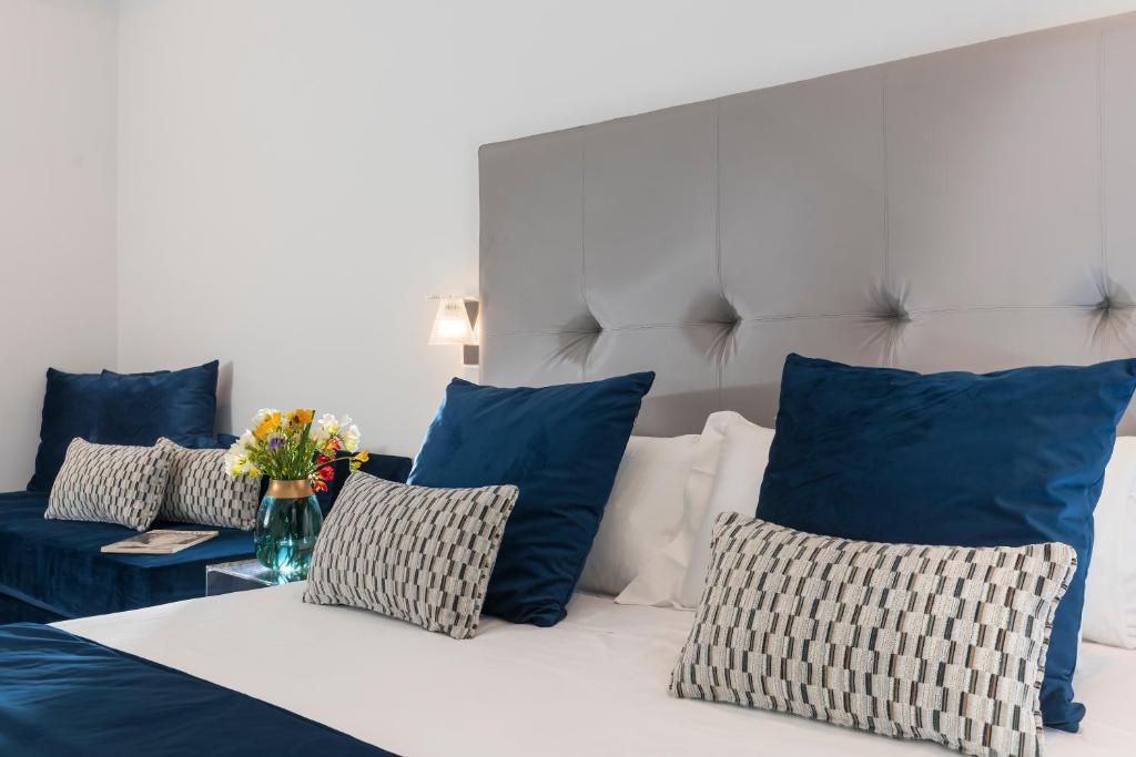 a bedroom with blue and white pillows and a bed at Residenza Zanardelli in Rome
