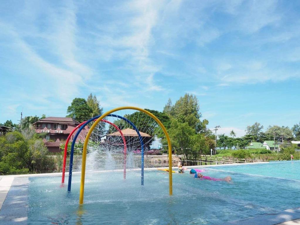 a water park with a water slide in a pool at Baan Imm Sook Resort in Chao Lao Beach