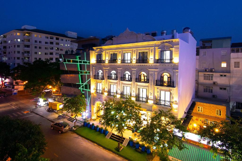 a building with lights on a city street at night at Sabina Boutique Hotel 2 in Ho Chi Minh City