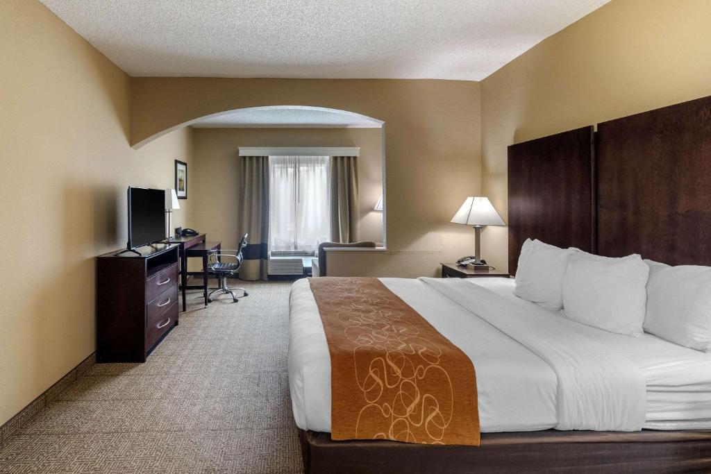 a hotel room with a large bed and a desk at Comfort Suites The Colony - Plano West in The Colony