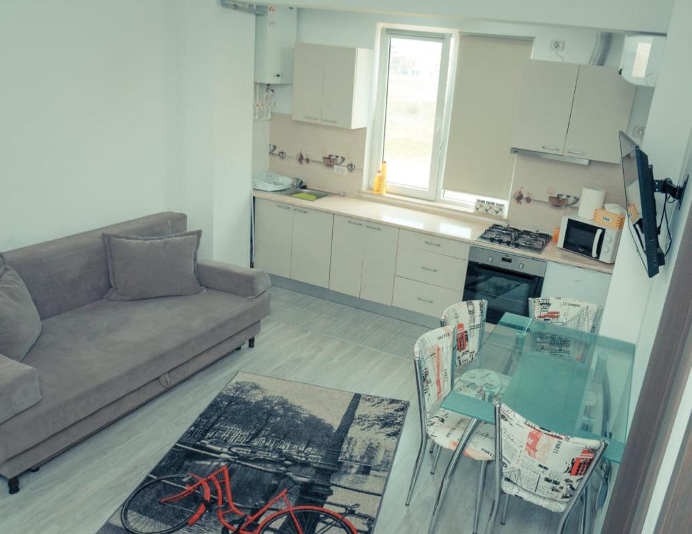 a living room with a couch and a glass table at Apartament #LUNA MAMAIA N in Mamaia Nord