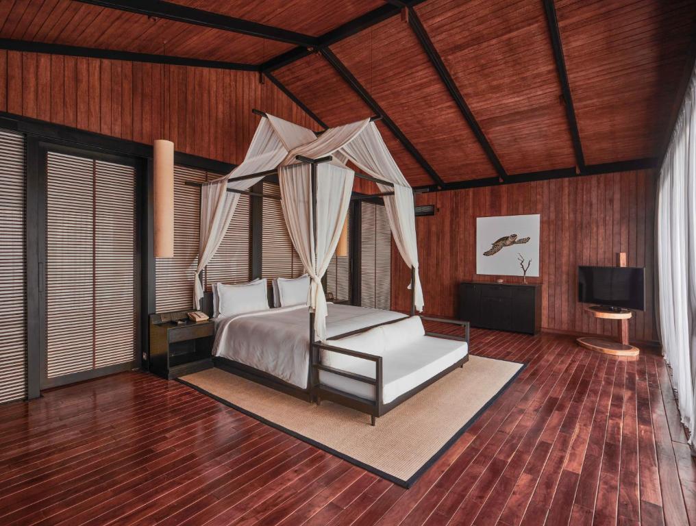 a bedroom with a bed with a canopy at Taj Exotica Resort & Spa, Andamans in Havelock Island