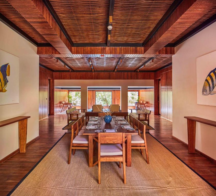 a dining room with a long table and chairs at Taj Exotica Resort & Spa, Andamans in Havelock Island