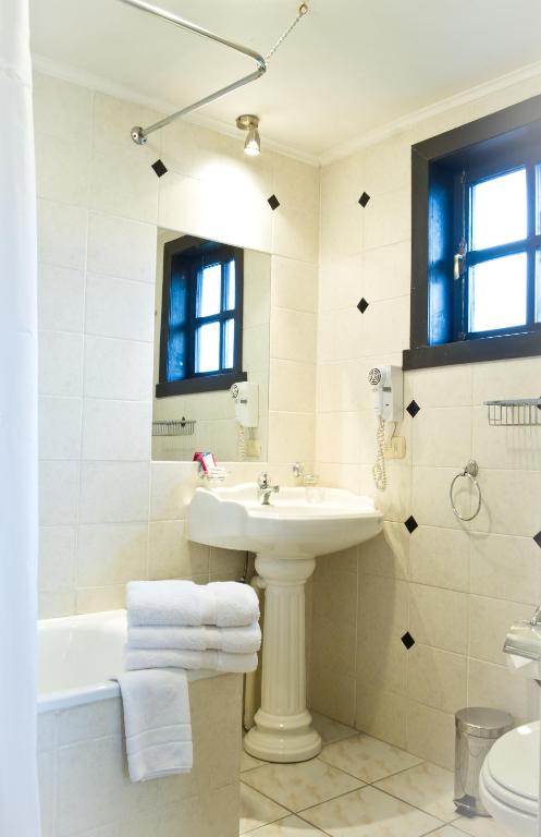 uma casa de banho com um lavatório, uma banheira e um WC. em Weisserhaus em Puerto Varas