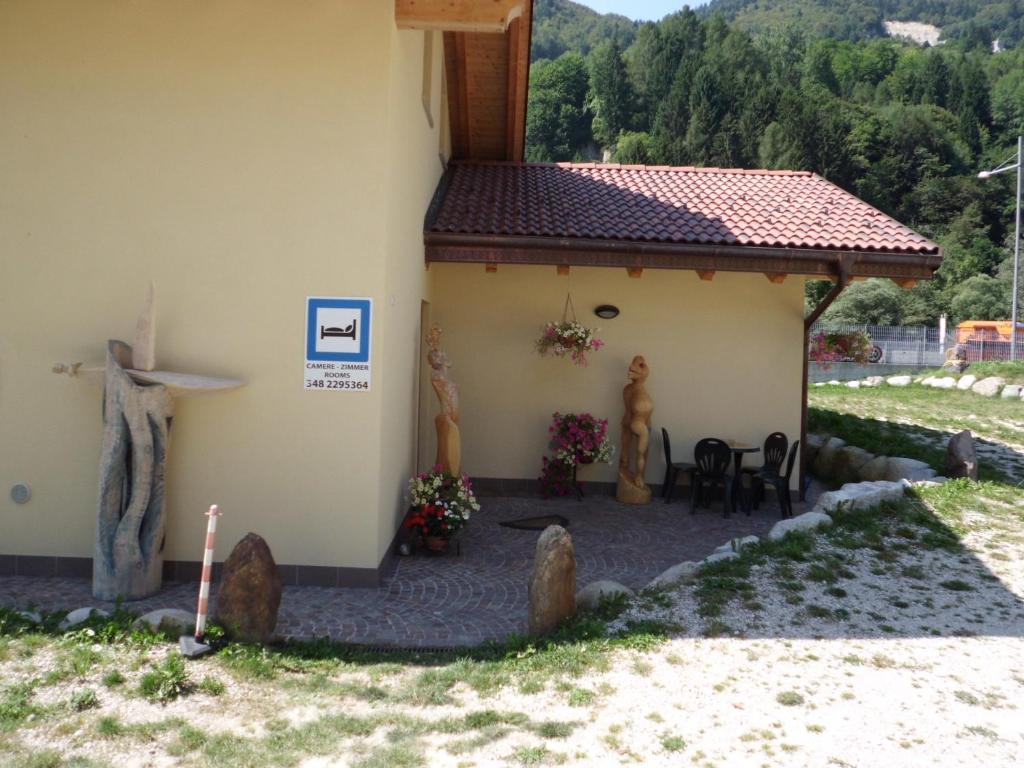 a small building with a table and chairs in front of it at Ai Vecchi Molini in Castello Tesino