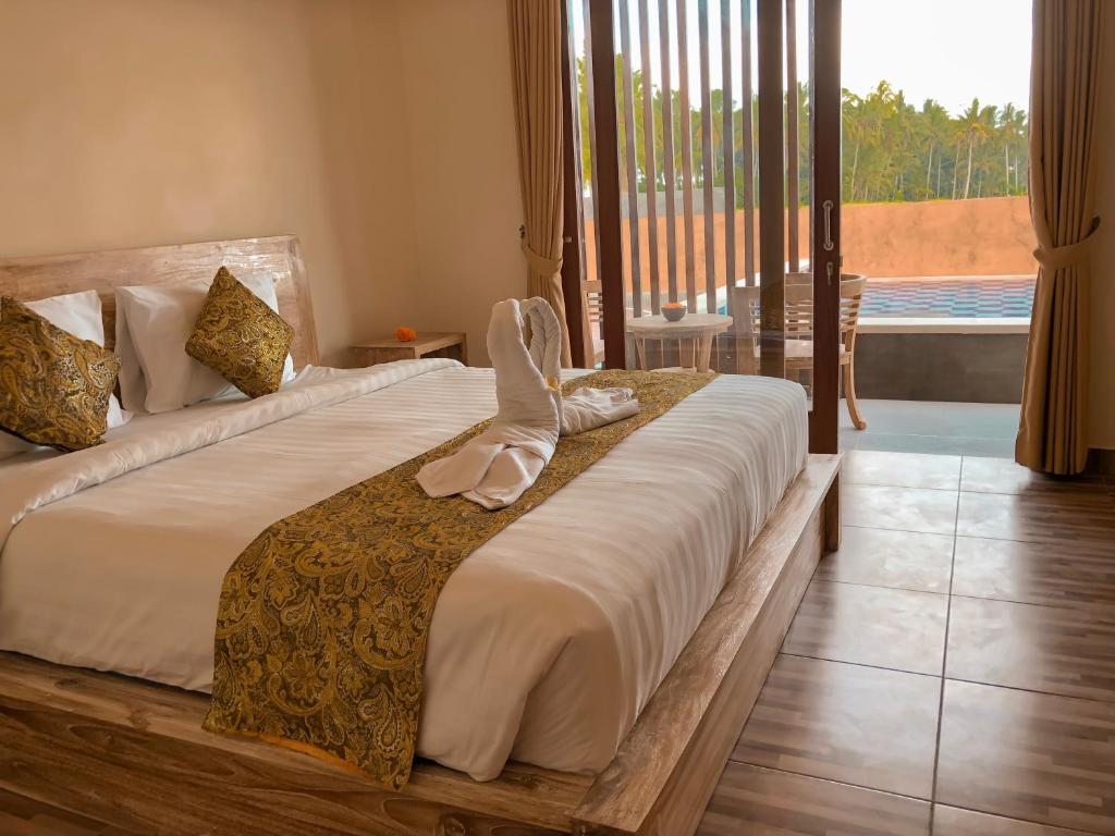 Postel nebo postele na pokoji v ubytování The Sawah Resort & Villa