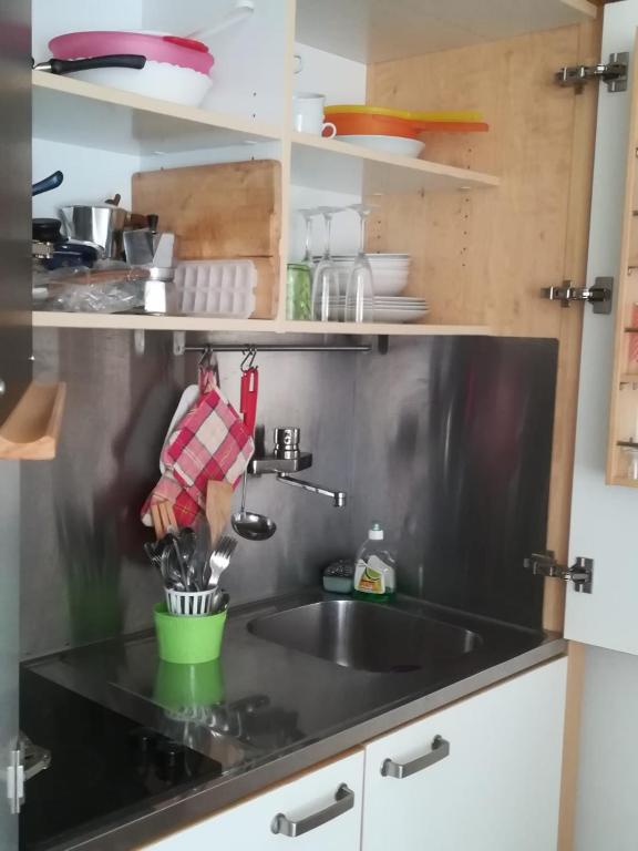 a kitchen counter with a sink and a person washing dishes at Chez Tamara with private parking and air conditioned in Monterosso al Mare