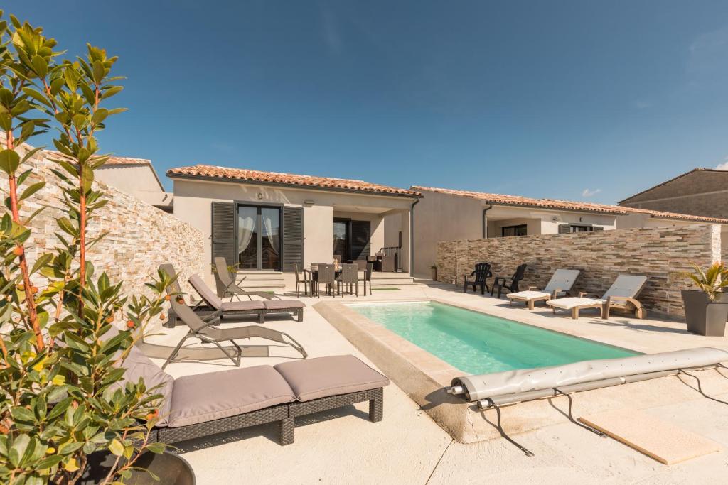 a villa with a swimming pool and a house at Le Domaine De Marie in Palasca