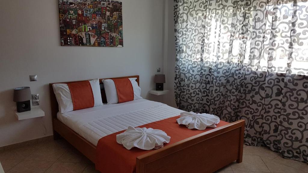 a small bedroom with a bed and a window at The Heart of Kissamos Studios in Kissamos