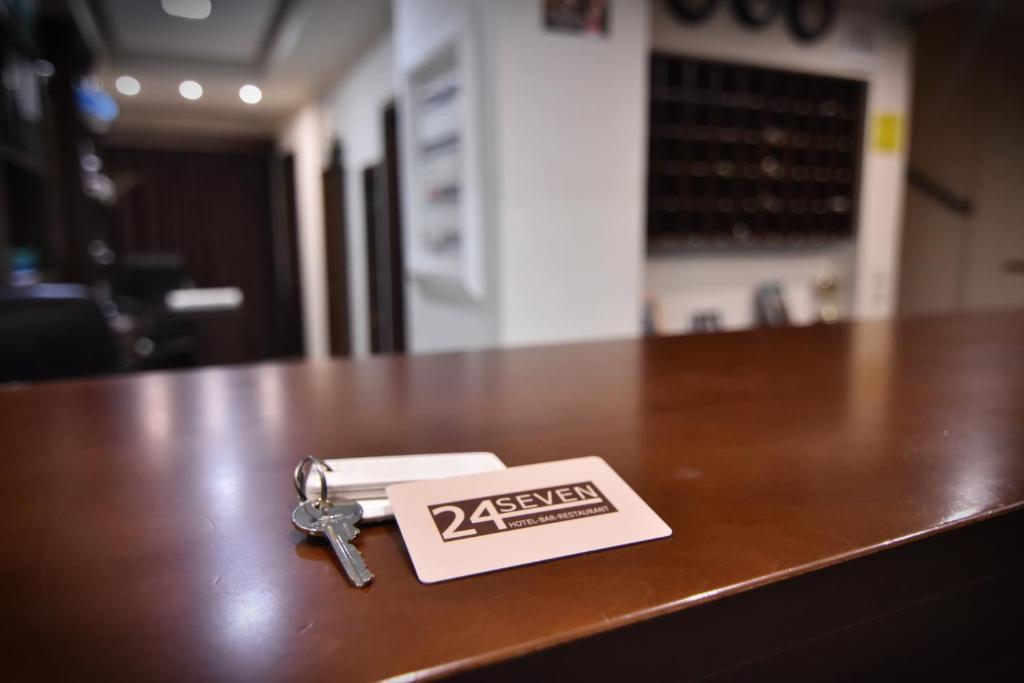 a pair of keys sitting on top of a table at 24 Seven Boutique Hotel in Malia