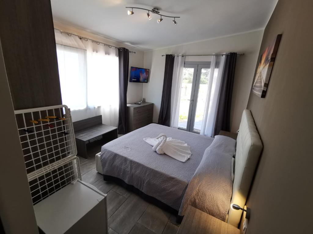 Кровать или кровати в номере Samanà B&B con Spiaggia Privata a Punta Prosciutto