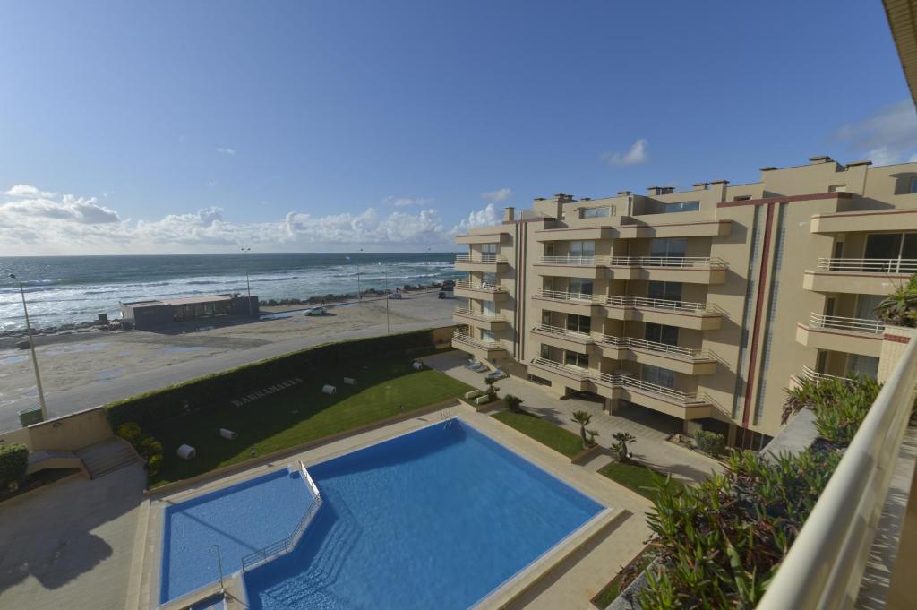 a view of the beach from the balcony of a building at Varandas do Sol in Ovar