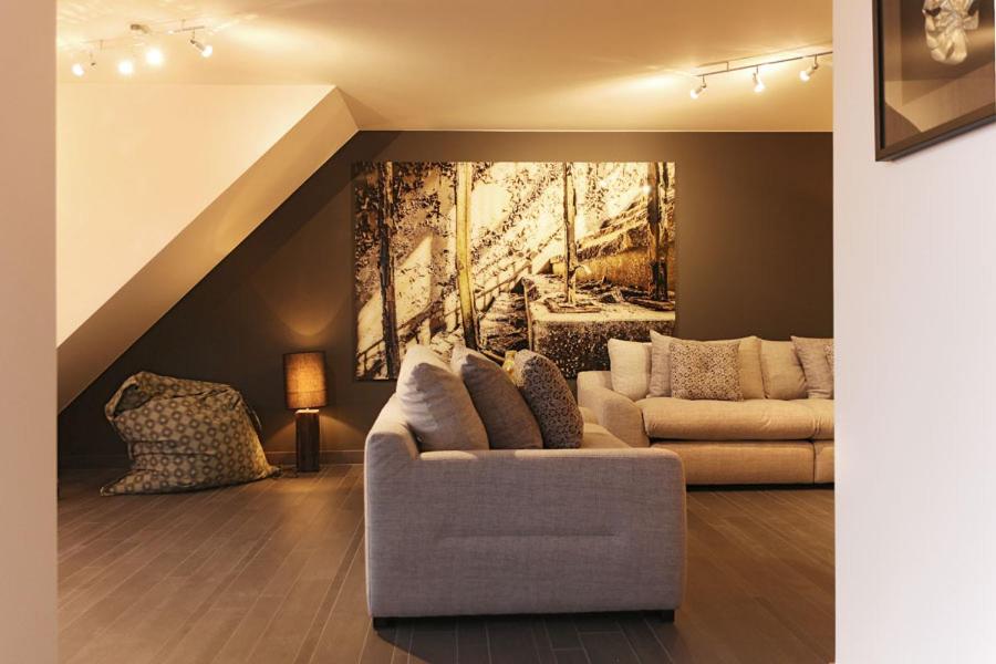 a living room with a couch and a painting on the wall at B2B Luxury Apartments Hotel Services Included in Knokke-Heist