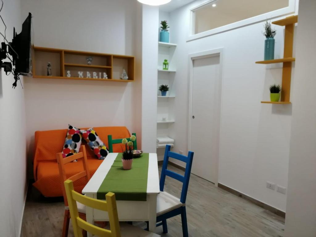 a dining room with a table and chairs and a couch at Casa vacanze Santa Maria in Bari