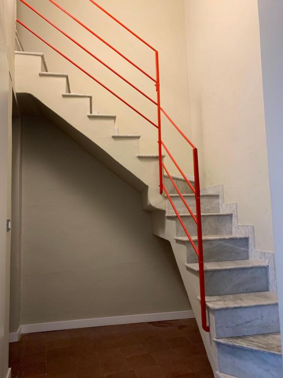 a staircase with a red railing in a room at Corte dei medici - Palace in Catania
