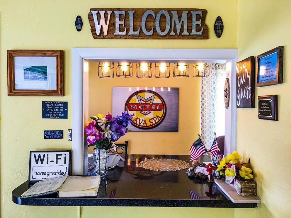a desk with a welcome sign on a wall at Lava Spa Motel & RV in Lava Hot Springs