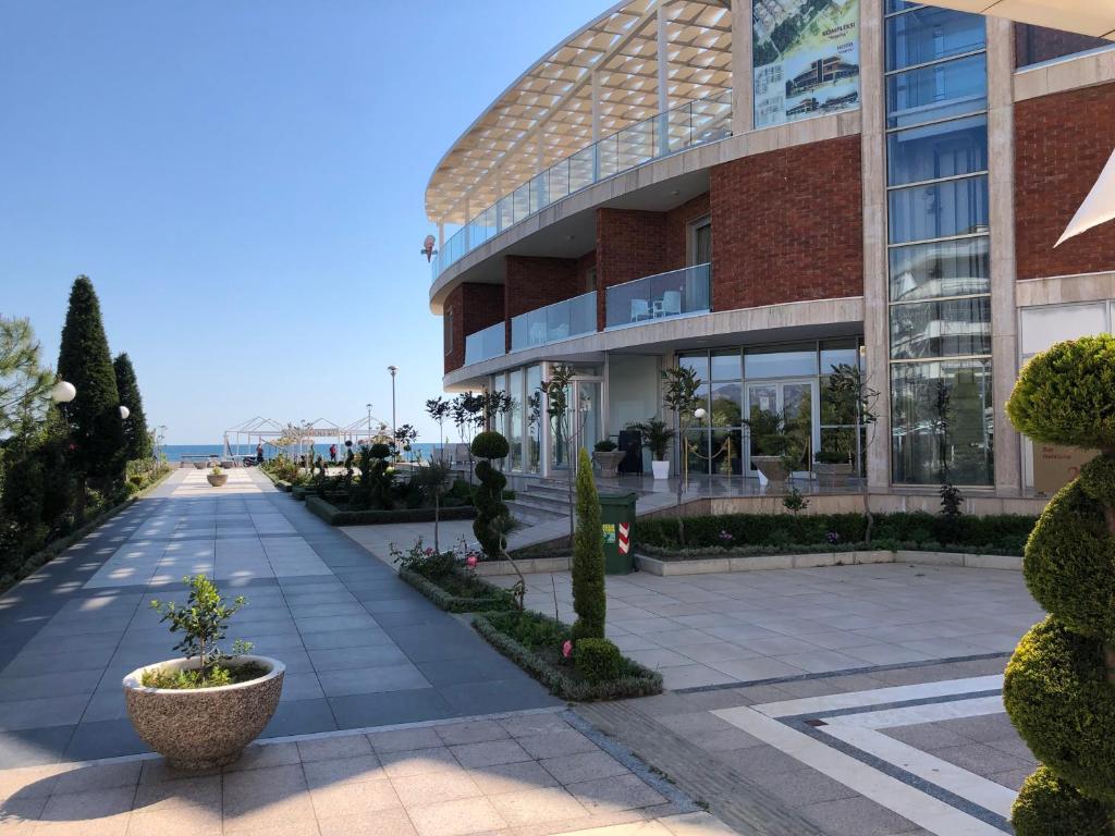 a building with a walkway in front of it at Fishta Hotel & Apartments in Velipojë