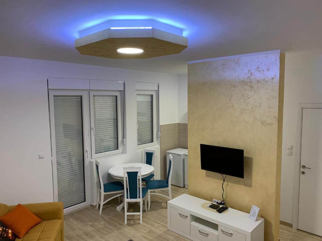 a living room with a table and a blue light at Airport view Apartment in Belgrade