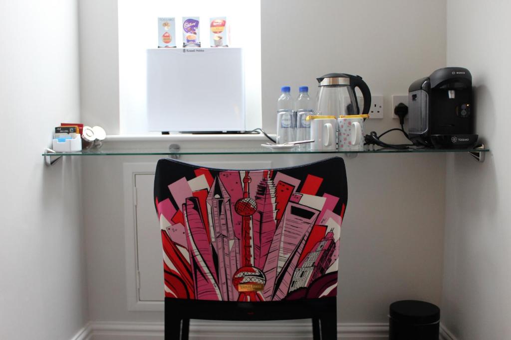 a chair sitting under a counter with a table at Elysian Fields B&B in Helston