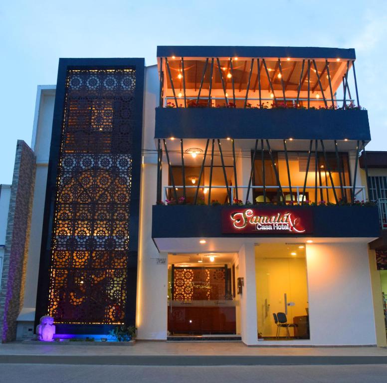 a building with a balcony on the side of it at Samalá Casa Hotel in Pitalito