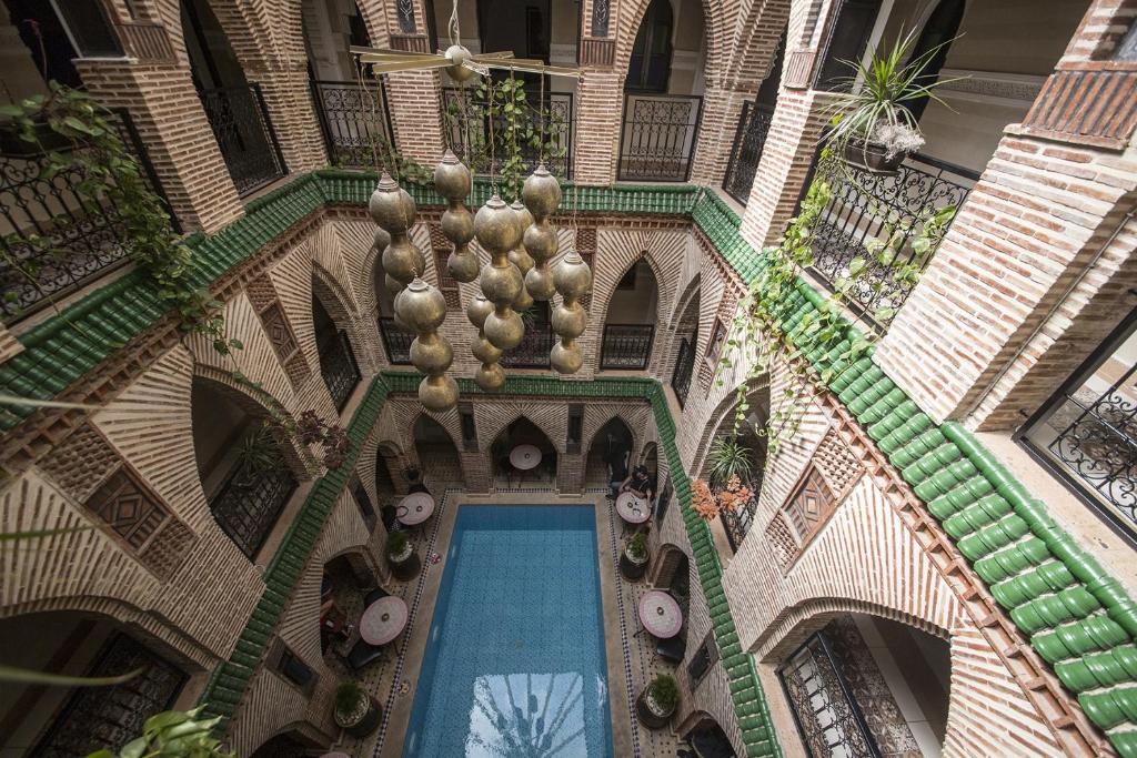 an overhead view of a building with a swimming pool at Riad Challa Hotel & Spa in Marrakesh