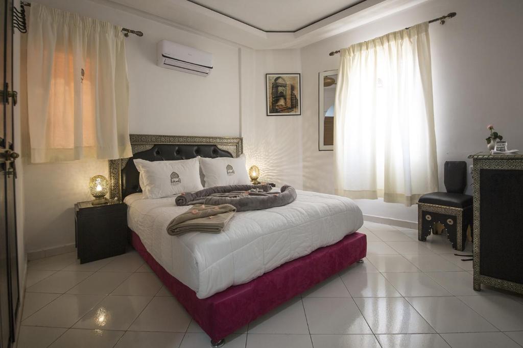 a bedroom with a large bed in a room at Riad Challa Hotel & Spa in Marrakesh