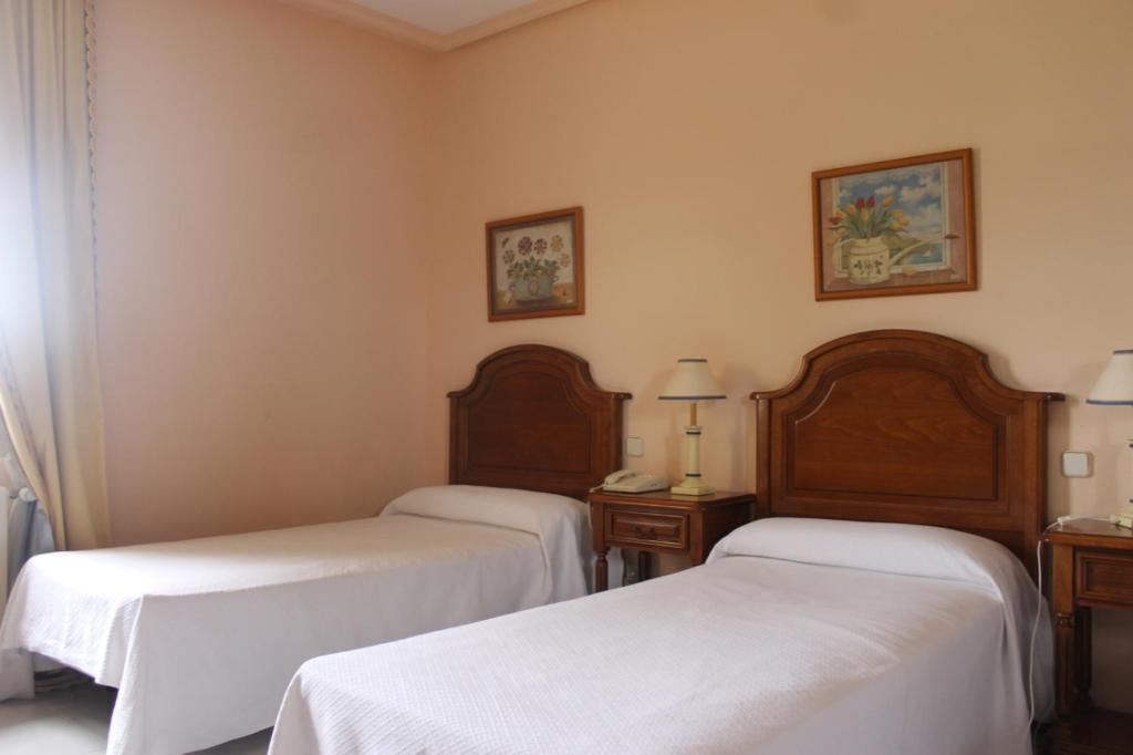 Postel nebo postele na pokoji v ubytování Hostal Las Paneras