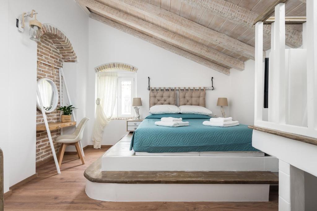 a white bedroom with a bed and a desk at Sky Loft Corfu Old Town Apartments in Corfu Town