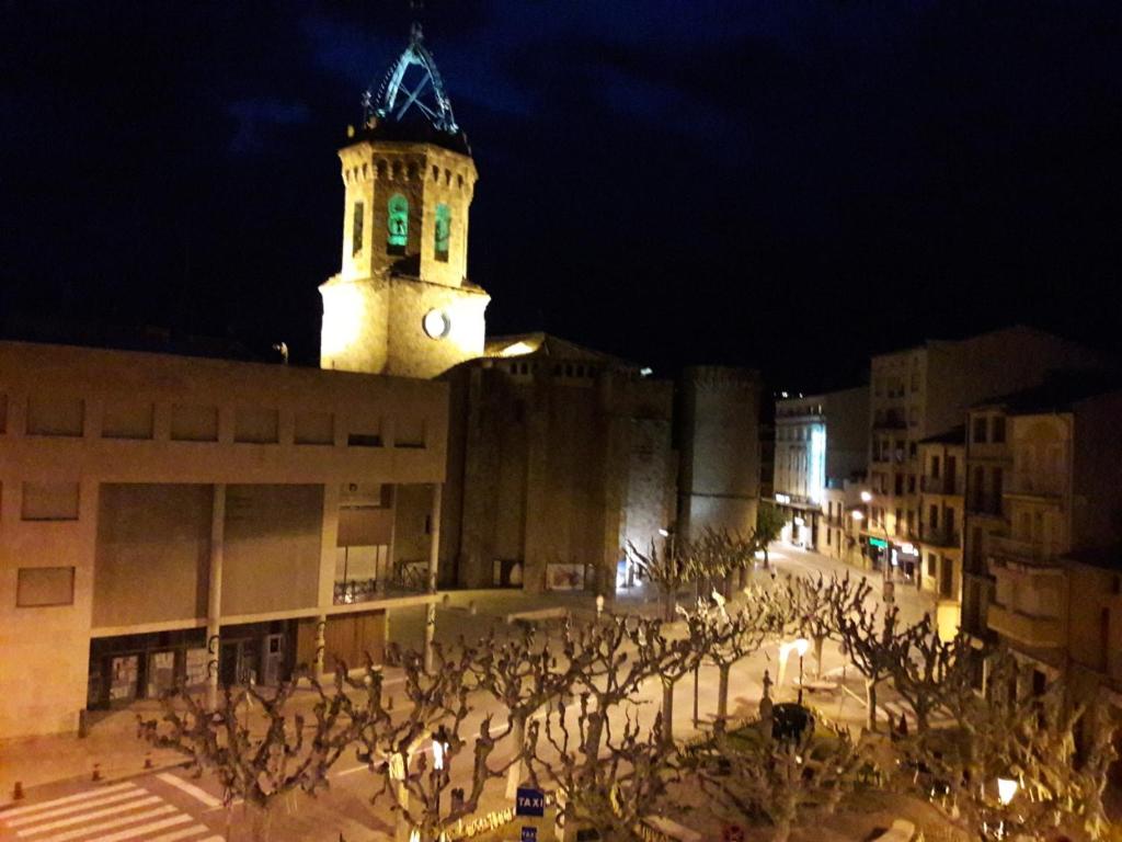 a building with a clock tower at night at Cal Richi in Tremp