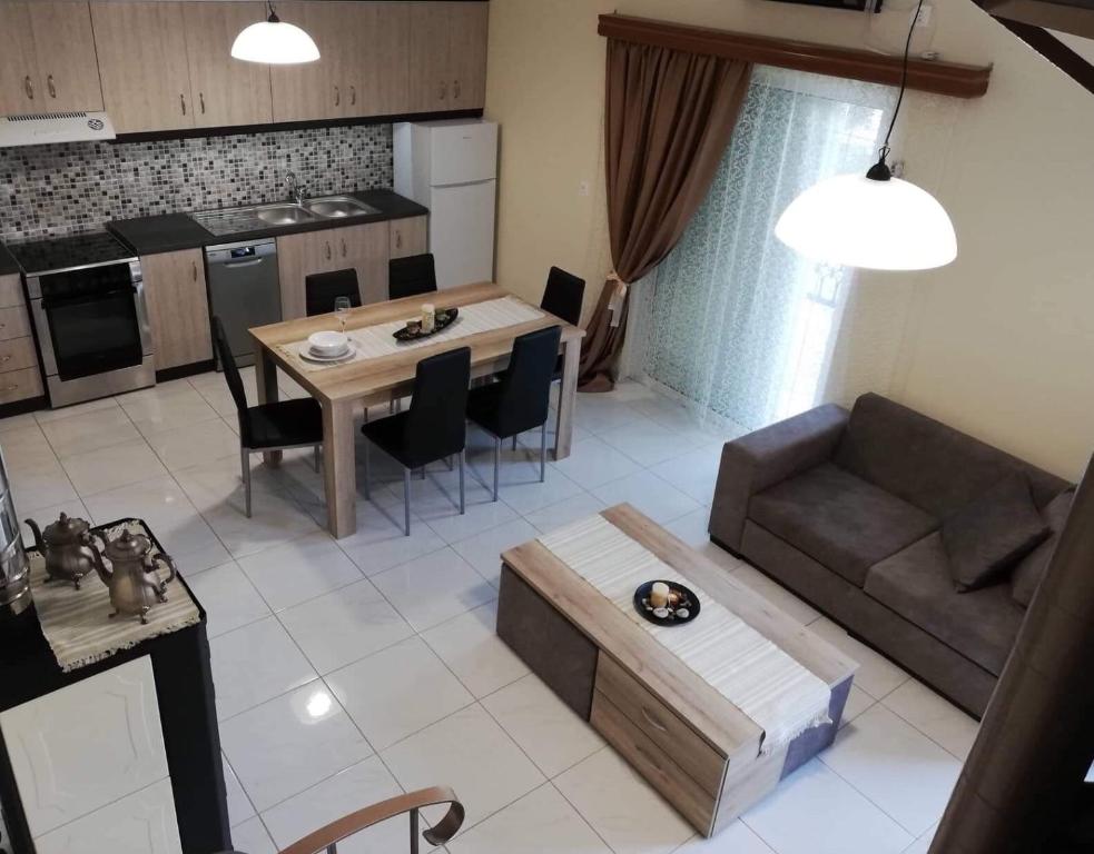 a kitchen and living room with a couch and a table at Anatoli View in Agia Marina Nea Kydonias