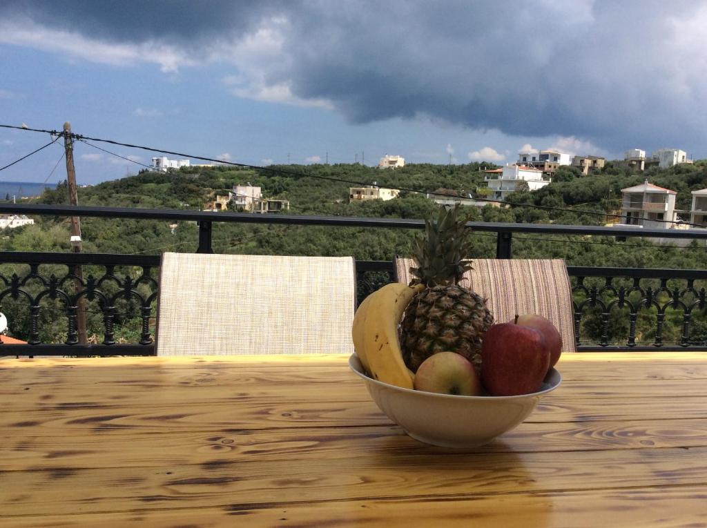a bowl of fruit on a table on a balcony at Anatoli View in Agia Marina Nea Kydonias