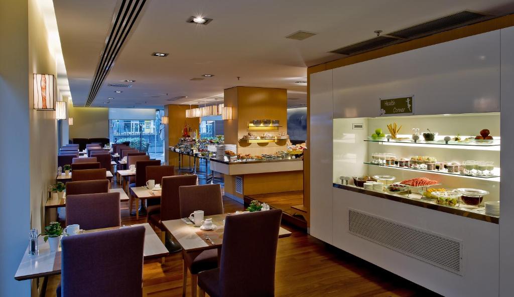 a restaurant with tables and chairs and a bar at Divan Istanbul City in Istanbul