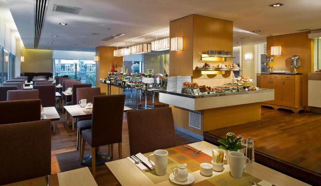 a restaurant with tables and chairs and a bar at Divan Istanbul City in Istanbul