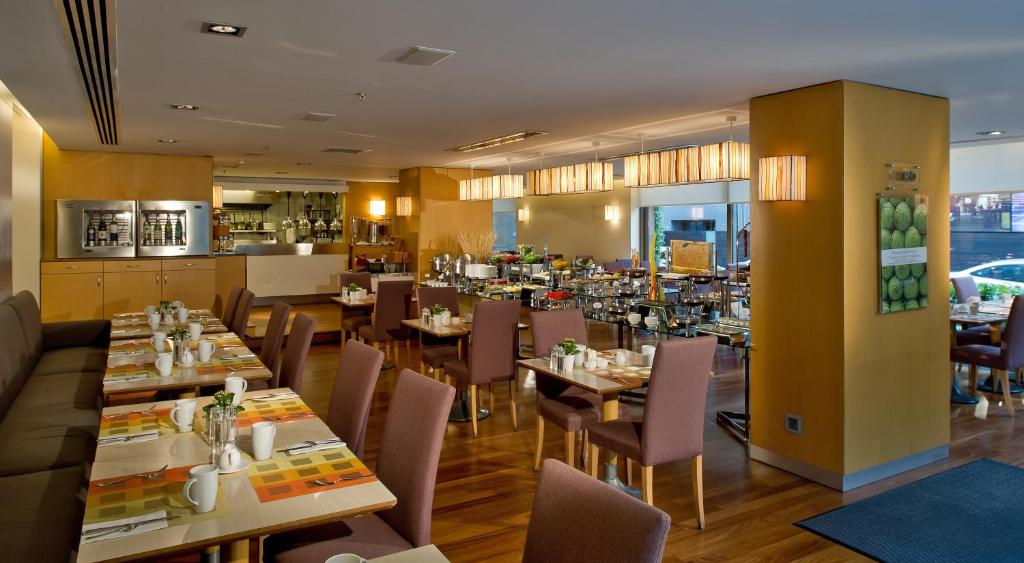 a dining room with tables and chairs in a restaurant at Divan Istanbul City in Istanbul