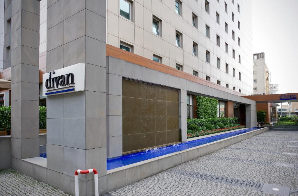 a building with a sign on the side of it at Divan Istanbul City in Istanbul