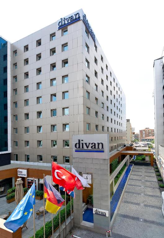 a hotel building with flags in front of it at Divan Istanbul City in Istanbul