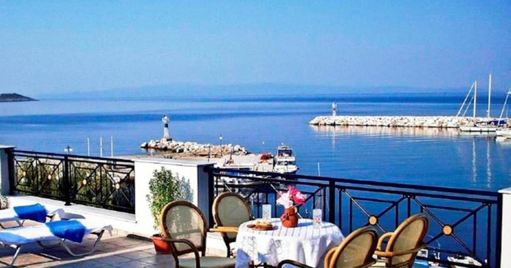 a balcony with a table and chairs and the ocean at Anna Maria - Vanessa Apartments in Neo Klima