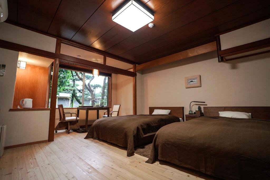 Postel nebo postele na pokoji v ubytování Ryokan Marumo