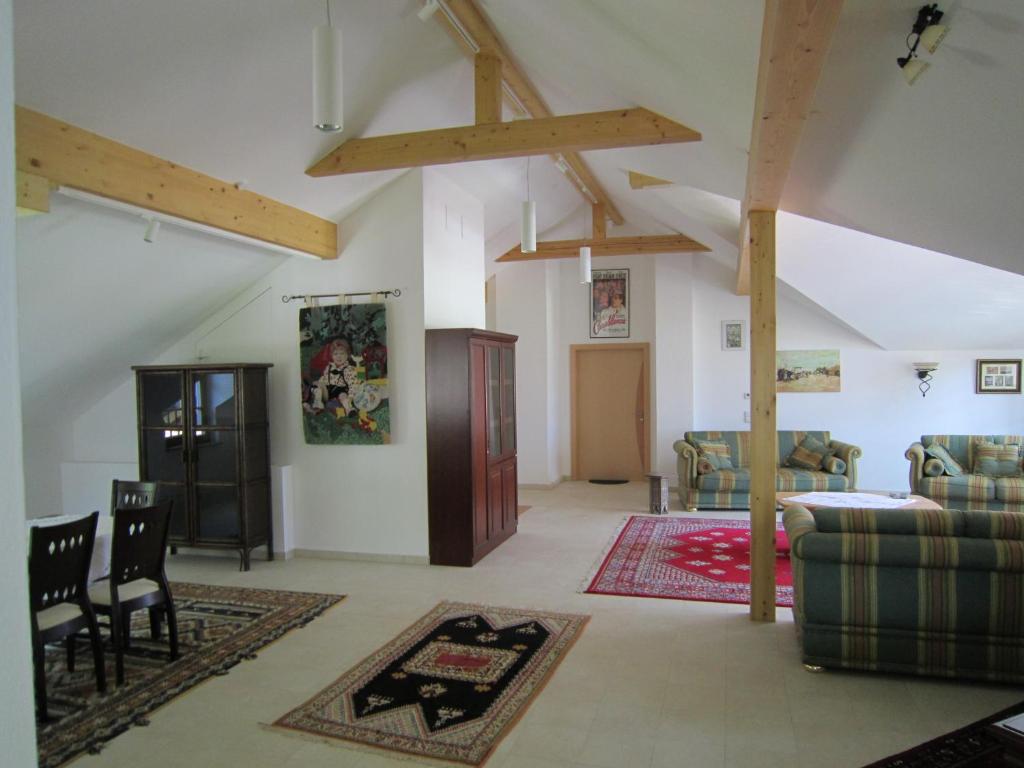 a living room with a couch and a chair at Haus Bellevue in Obertraun