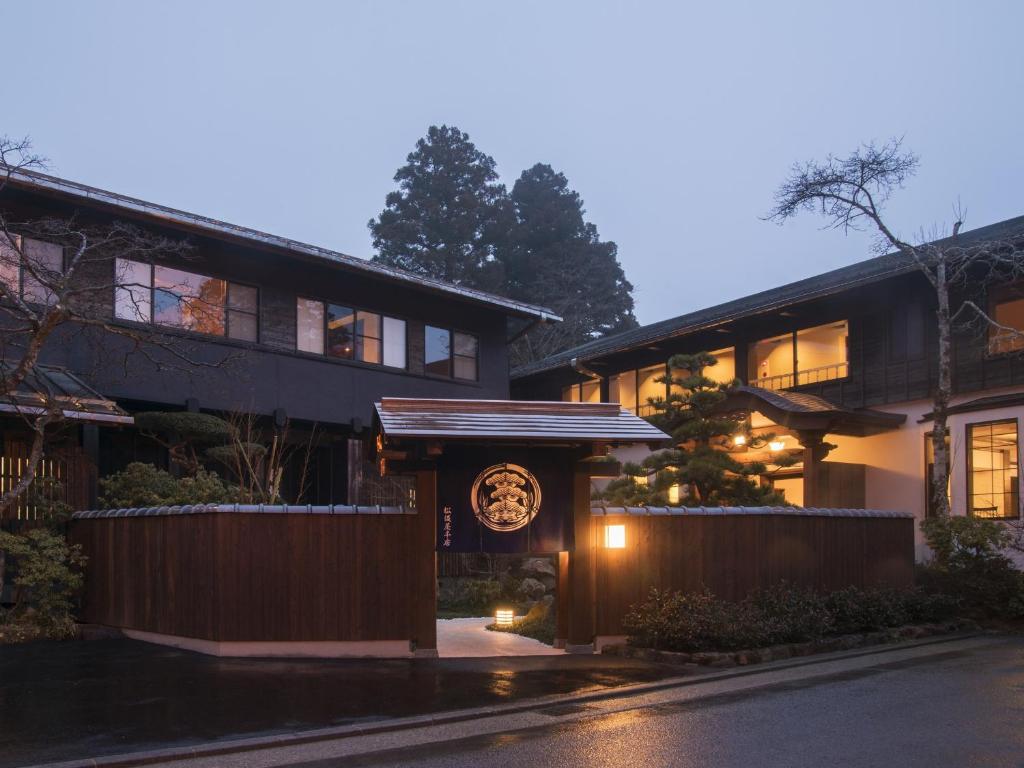 a house with a clock on the front of it at Matsuzakaya Honten in Hakone