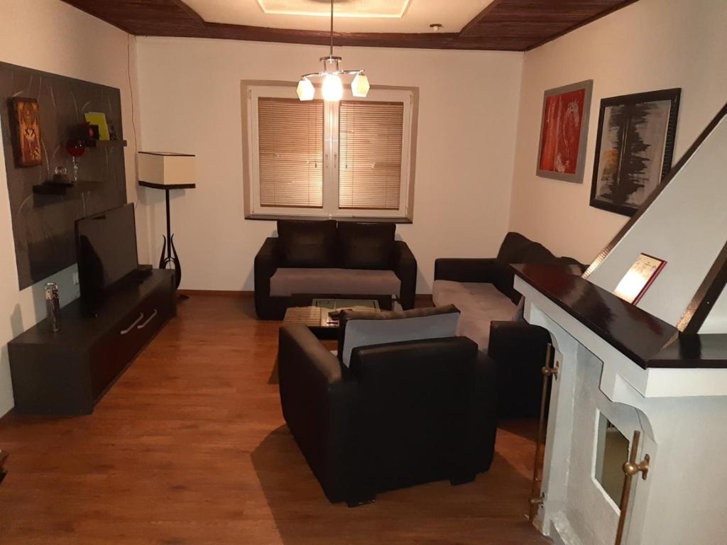 a living room with black furniture and a fireplace at Apartment NIKOLA ORANGE in Ohrid