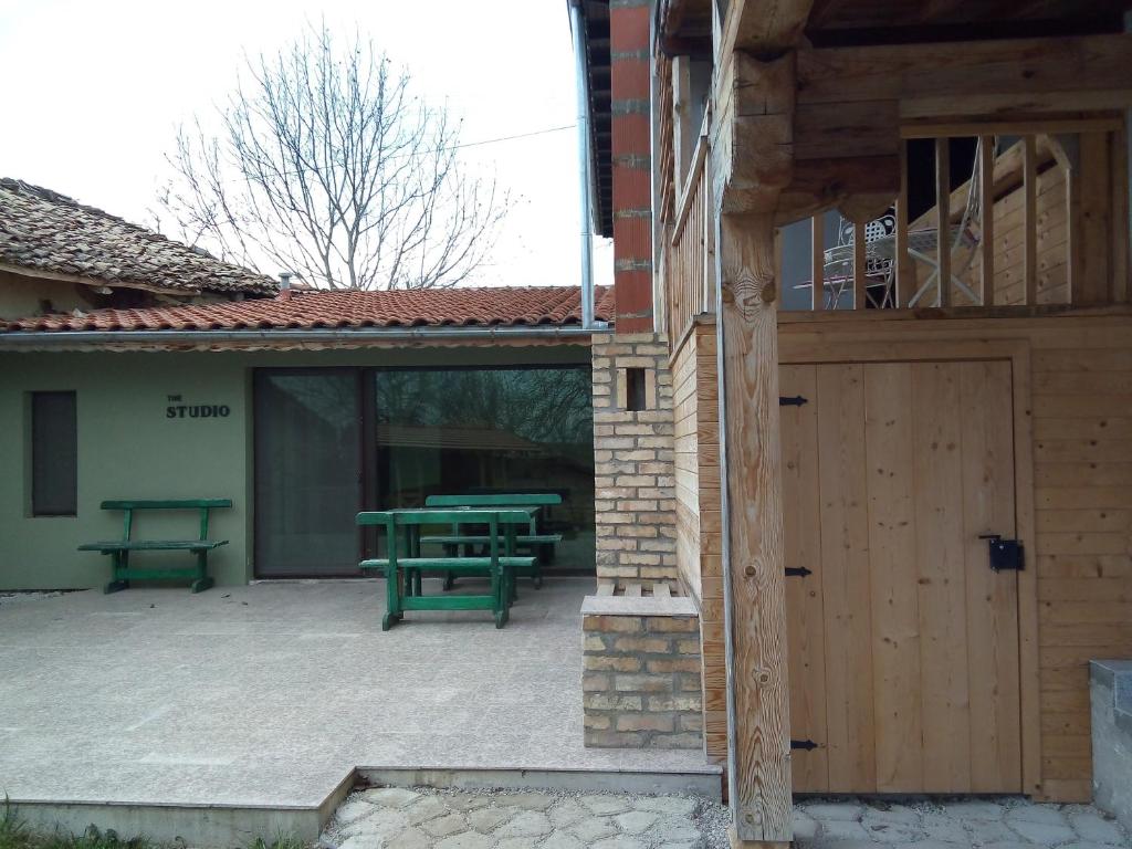 a patio with a picnic table and a wooden door at Studio Apartment in Palamartsa in Palamarca