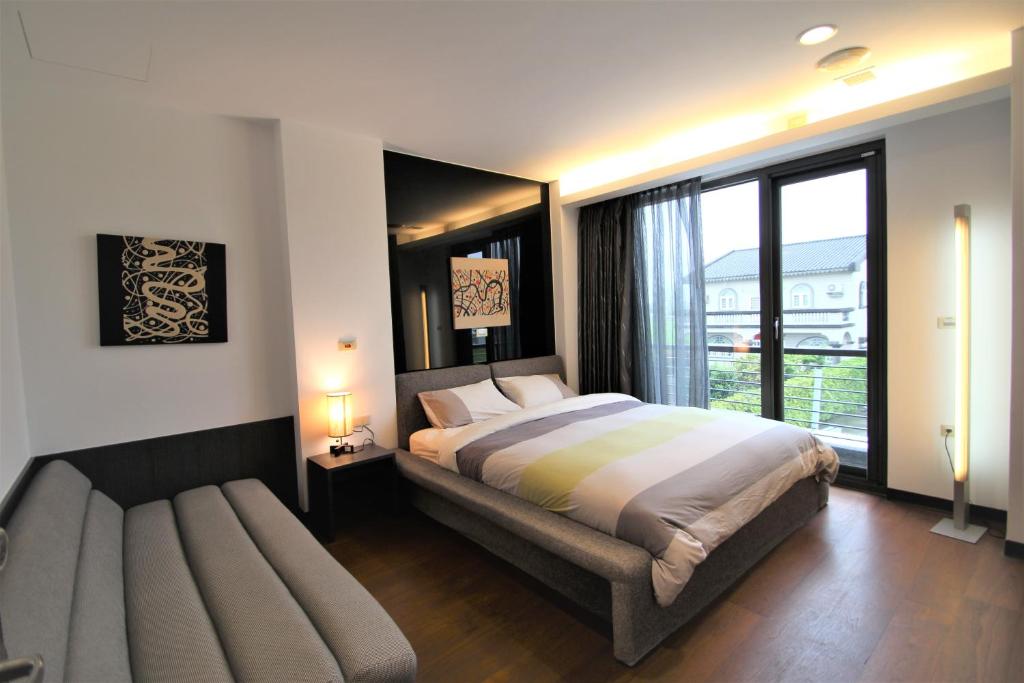a bedroom with a large bed and a window at The Designer&#39;s House in Wujie